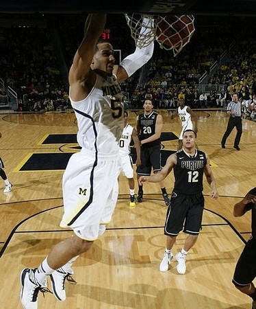 Jordan Morgan (52), Derrick Walton Jr. (10), and Caris LeVert (23)
