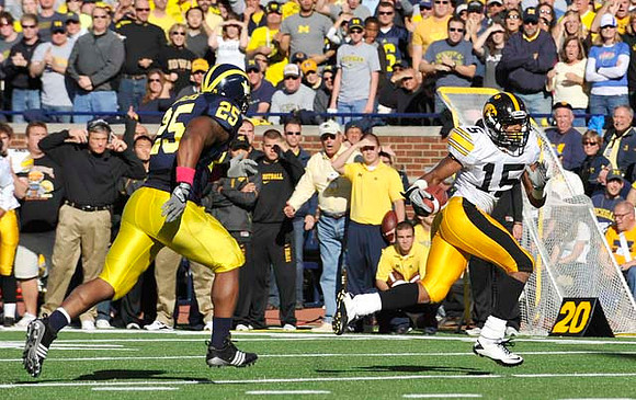 Kenny Demens (25) and Kirk Ferentz