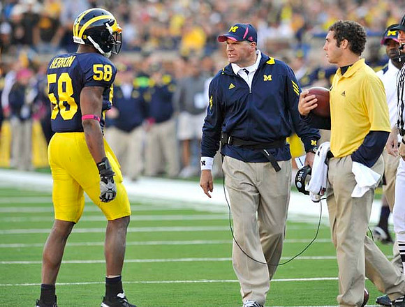 Brandon Herron (58) and Rich Rodriguez