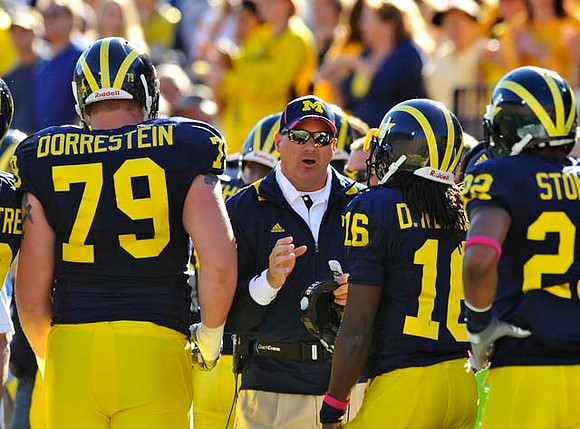Perry Dorrestein (79), Rich Rodriguez, Denard Robinson (16), and Darryl Stonum (22)