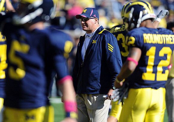 Tate Forcier (5), Rich Rodriguez, Ryan Van Bergen (53), and Roy Roundtree (12)