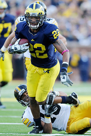 Taylor Lewan (77) and Darryl Stonum (22)