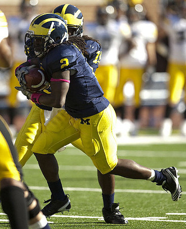 Vincent Smith (2) and Denard Robinson (16)
