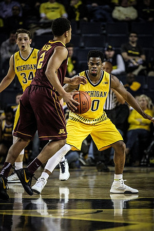 Mark Donnal (34) and Derrick Walton Jr. (10)