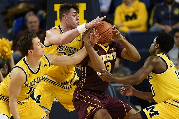 Andrew Dakich (11), Ricky Doyle (32), and Derrick Walton Jr. (10)