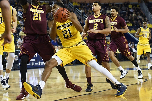 Mark Donnal (34), Zak Irvin (21), and Derrick Walton Jr. (10)