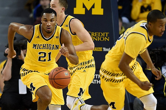 Zak Irvin (21), Duncan Robinson (22), and Muhammad-Ali Abdur-Rahkman (12)
