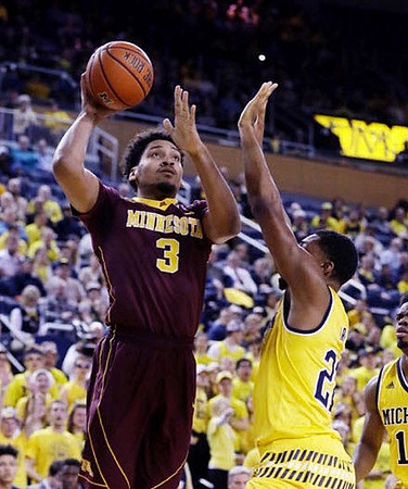 Zak Irvin (21) and Derrick Walton Jr. (10)