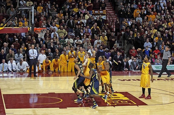 Jon Horford (15), Caris LeVert (23), and Minnesota Head Coach Richard Pitino