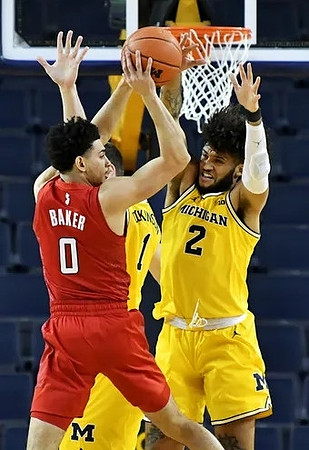 Hunter Dickinson (1) and Isaiah Livers (2)