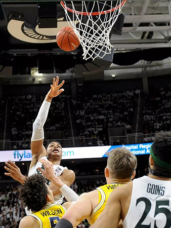 D.J. Wilson (5) and Moritz Wagner (13)