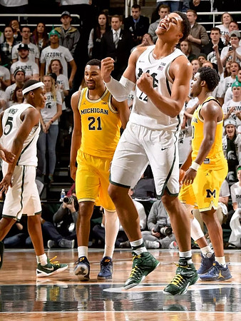 Zak Irvin (21) and Derrick Walton Jr. (10)