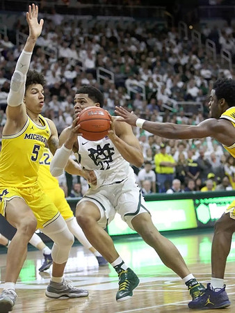 D.J. Wilson (5) and Derrick Walton Jr. (10)