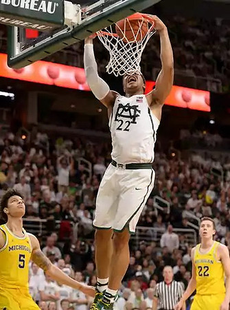 D.J. Wilson (5) and Duncan Robinson (22)