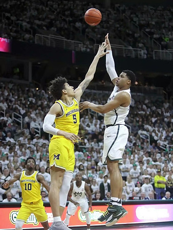 Derrick Walton Jr. (10) and D.J. Wilson (5)