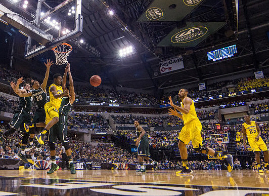 Derrick Walton Jr. (10), Jon Horford (15), and Caris LeVert (23)