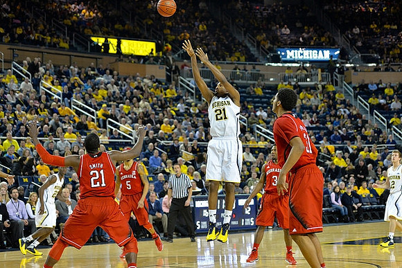 Zak Irvin (21), Caris LeVert (23), and Spike Albrecht (2)