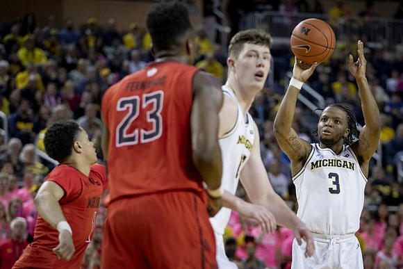 Jon Teske (15) and Zavier Simpson (3)