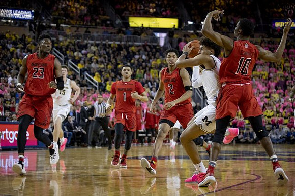 Jon Teske (15) and Jordan Poole (2)