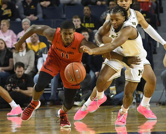 Zavier Simpson (3) and Isaiah Livers (4)