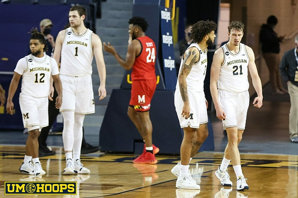 Mike Smith (12), Hunter Dickinson (1), Isaiah Livers (2), and Franz Wagner (21)