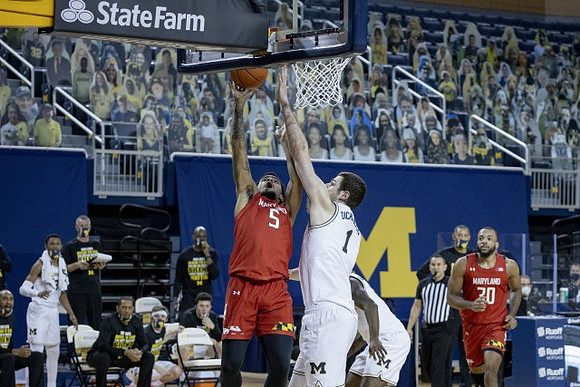 Hunter Dickinson (1) and Chaundee Brown Jr. (15)