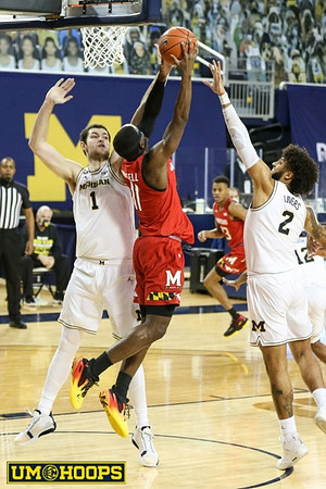 Hunter Dickinson (1), Isaiah Livers (2), and Mike Smith (12)