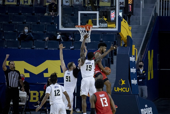 Mike Smith (12), Austin Davis (51), and Chaundee Brown Jr. (15)