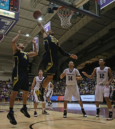 Mitch McGary (4) and Jordan Morgan (52)