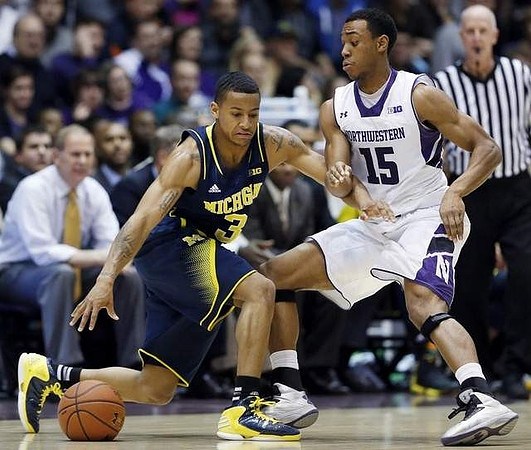 Trey Burke (3) and John Beilein