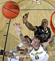 Zack Novak (0), Manny Harris (3) and Kelvin Grady (44)