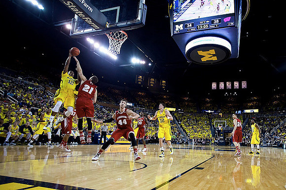 Derrick Walton Jr. (10), Muhammad-Ali Abdur-Rahkman (12), John Beilein, and Zak Irvin (21)