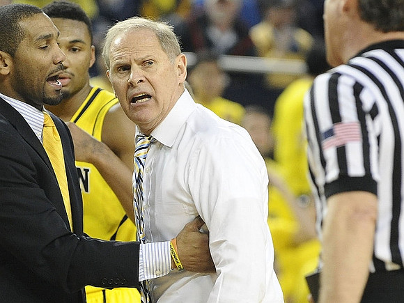 LaVall Jordan, Zak Irvin (21), and John Beilein