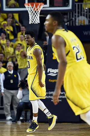 Derrick Walton Jr. (10) and Zak Irvin (21)
