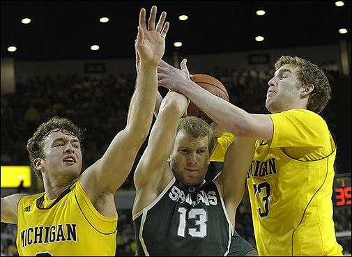 Zack Novak (0) and Evan Smotrycz (23)