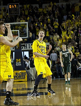 Zack Novak (0) and Evan Smotrycz (23)