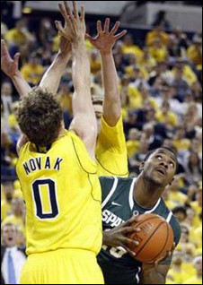 Zack Novak (0) and Evan Smotrycz (23)
