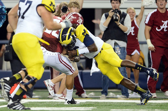 Elliott Mealer (57) and Denard Robinson (16)