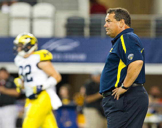 Jordan Kovacs (32) and Brady Hoke