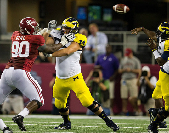 Michael Schofield (75) and Denard Robinson (16)