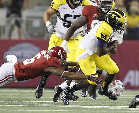 Denard Robinson (16) and Elliott Mealer (57)