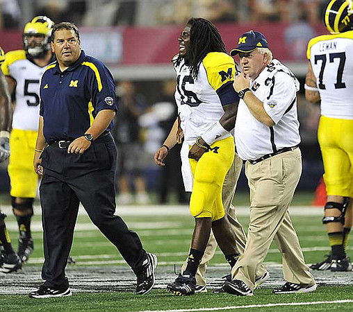 Brady Hoke, Denard Robinson (16), and Taylor Lewan (77)