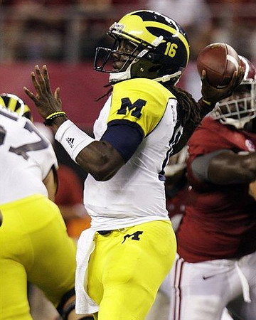 Elliott Mealer (57) and Denard Robinson (16)