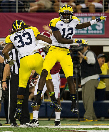 Stephen Hopkins (33) and Devin Gardner (12)