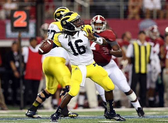 Taylor Lewan (77) and Denard Robinson (16)