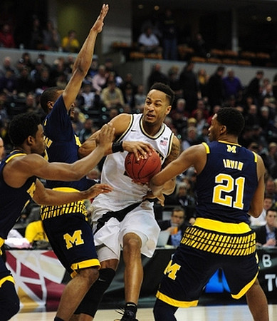 Derrick Walton Jr. (10), Muhammad-Ali Abdur-Rahkman (12), and Zak Irvin (21)