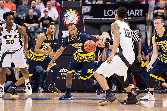 Zak Irvin (21), Muhammad-Ali Abdur-Rahkman (12), and Duncan Robinson (22)