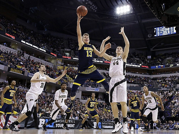 Zak Irvin (21), Moritz Wagner (13), Aubrey Dawkins (24), and Derrick Walton Jr. (10)