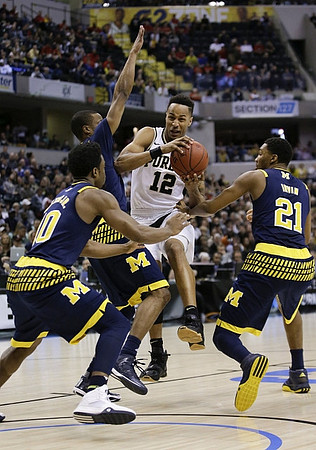 Derrick Walton Jr. (10), Muhammad-Ali Abdur-Rahkman (12), and Zak Irvin (21)