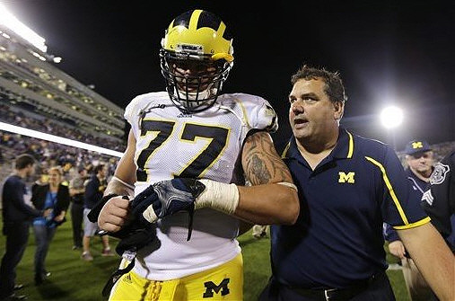 Taylor Lewan (77) and Brady Hoke